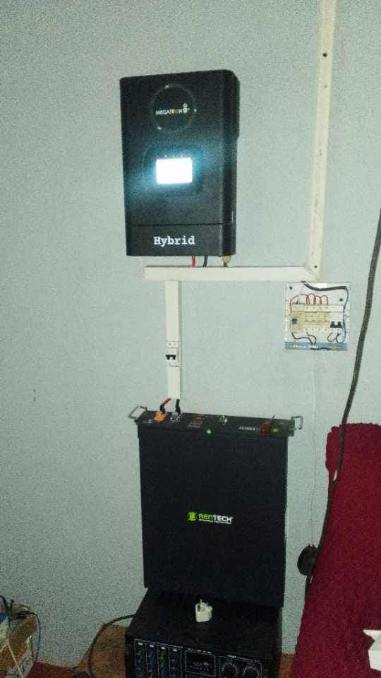 Hybrid inverter and battery installed on a home wall