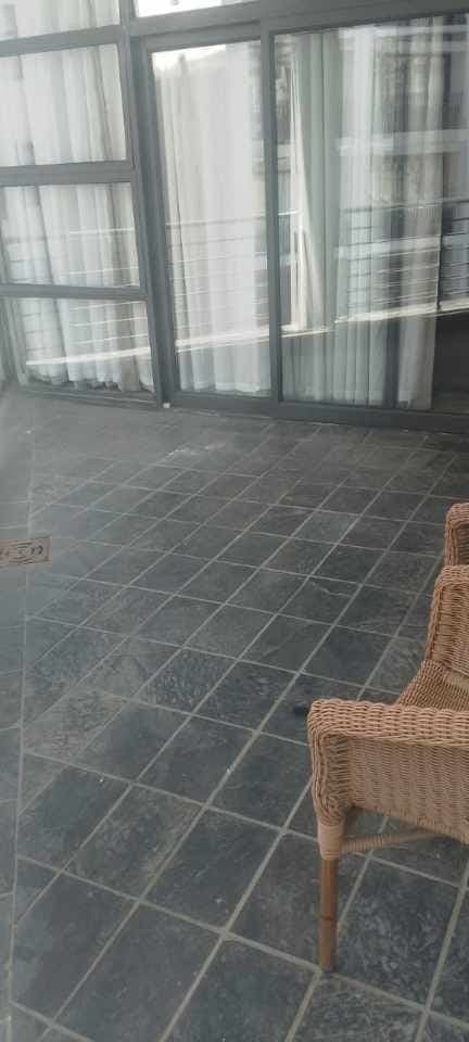 Tiled patio with a floor drain after waterproofing work